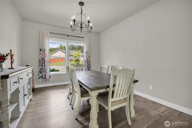 13800 27th Dr NW, Tulalip, WA 98271 - dining area featuring a chandelier, wood finished floors, and baseboards