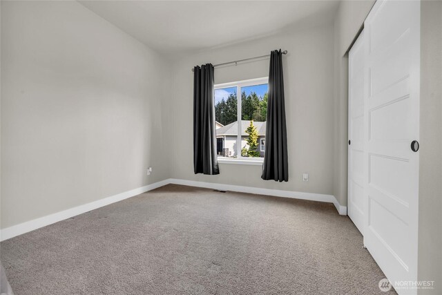 13800 27th Dr NW, Tulalip, WA 98271 - spare room featuring carpet flooring and baseboards