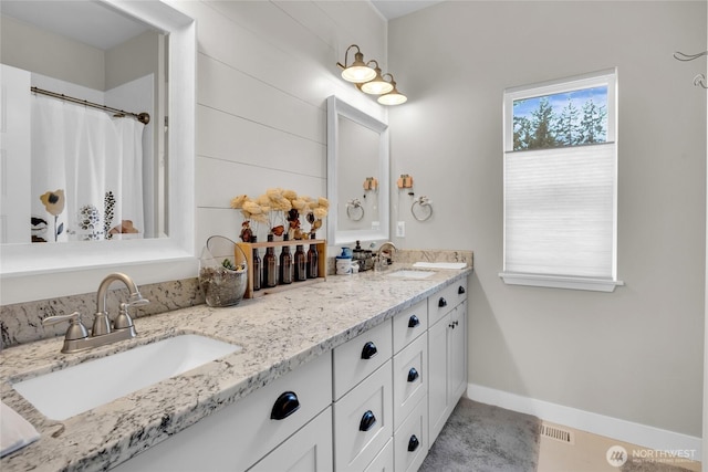 13800 27th Dr NW, Tulalip, WA 98271 - full bath featuring double vanity, baseboards, and curtained shower