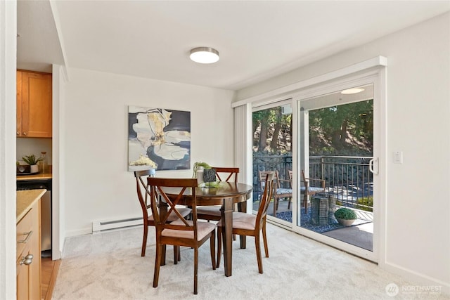 15212 NE 8th St Unit F3, Bellevue, WA 98007 - dining room featuring a baseboard radiator, light colored carpet, and baseboards
