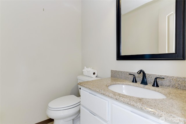 bathroom featuring toilet and vanity