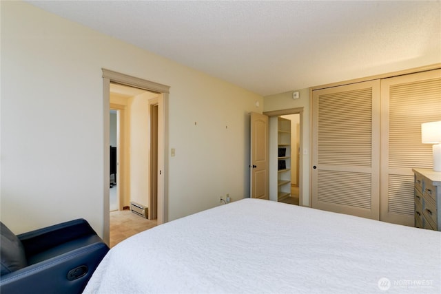 bedroom featuring a closet and a baseboard radiator