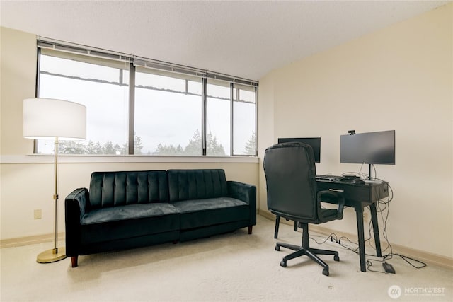 carpeted office featuring baseboards and plenty of natural light