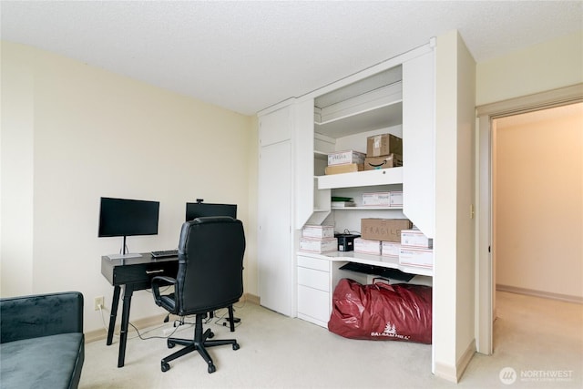 office space featuring light carpet and baseboards