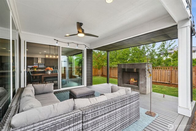 20006 149th St E, Bonney Lake, WA 98391 - sunroom / solarium with ceiling fan, an outdoor living space with a fireplace, and healthy amount of natural light