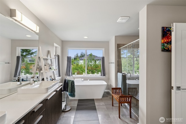 20006 149th St E, Bonney Lake, WA 98391 - bathroom featuring a shower stall, double vanity, plenty of natural light, a freestanding tub, and recessed lighting