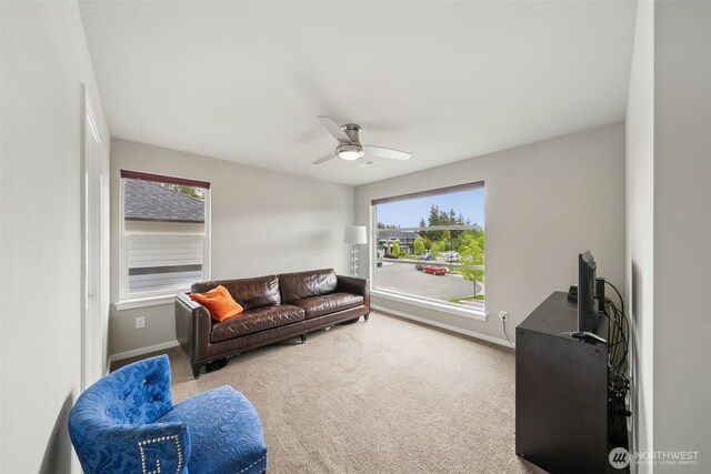 20006 149th St E, Bonney Lake, WA 98391 - carpeted living area with baseboards and ceiling fan