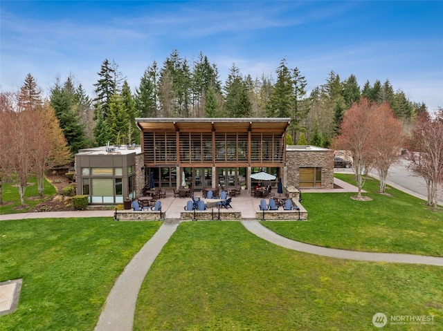 20006 149th St E, Bonney Lake, WA 98391 - rear view of property with a patio area, a yard, stone siding, and a multi sided fireplace