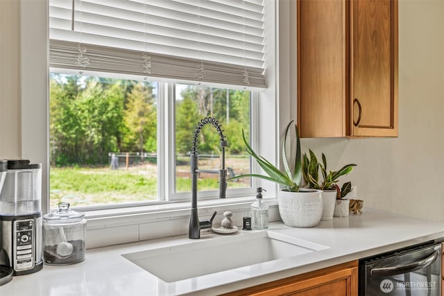 266 Fir Rd, Ariel, WA 98603 - kitchen view of a sink, dishwashing machine, light countertops, and brown cabinetry