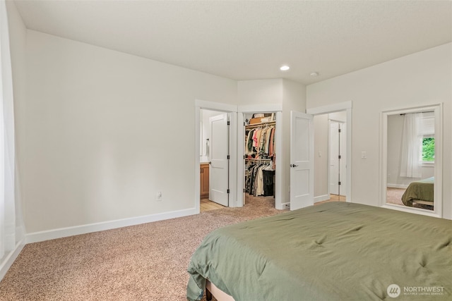 266 Fir Rd, Ariel, WA 98603 - bedroom with light colored carpet, baseboards, recessed lighting, a spacious closet, and ensuite bathroom