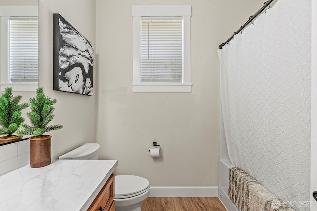 266 Fir Rd, Ariel, WA 98603 - full bath with baseboards, wood finished floors, toilet, vanity, and shower / bath combo with shower curtain