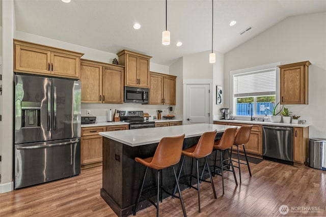 266 Fir Rd, Ariel, WA 98603 - kitchen featuring appliances with stainless steel finishes, a kitchen island, wood finished floors, light countertops, and recessed lighting