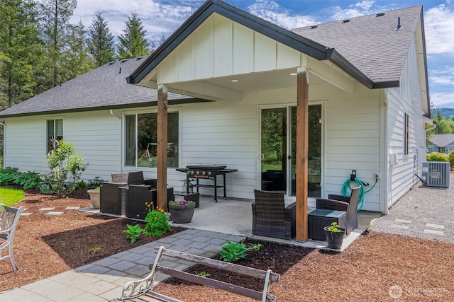 266 Fir Rd, Ariel, WA 98603 - back of house with roof with shingles, a patio area, central AC unit, and board and batten siding