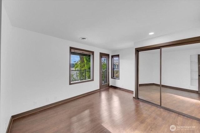 16015 Inglewood Rd NE, Kenmore, WA 98028 - unfurnished bedroom with wood finished floors, baseboards, recessed lighting, and a closet