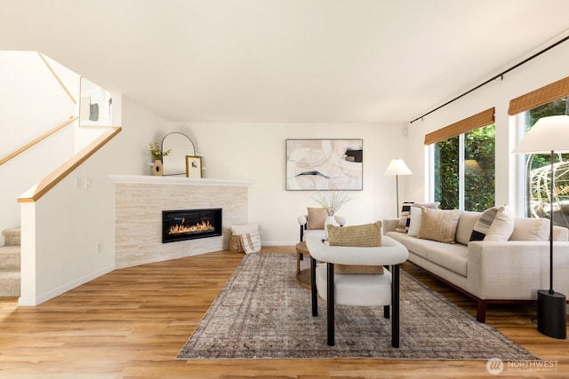 17427 92nd Ave NE, Bothell, WA 98011 - living room featuring wood finished floors, a tile fireplace, stairway, and baseboards