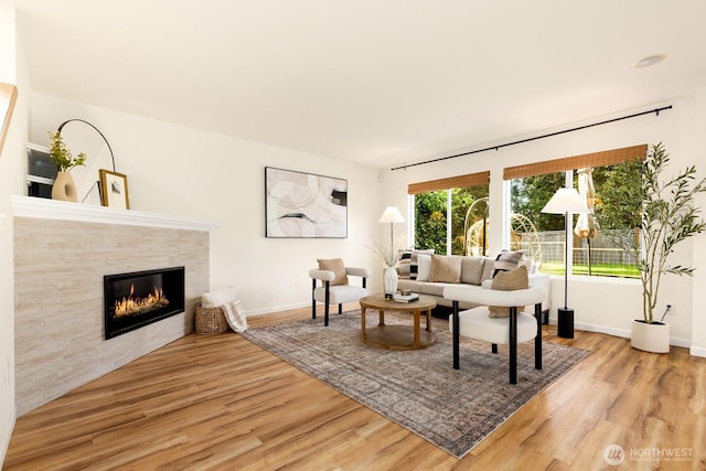 17427 92nd Ave NE, Bothell, WA 98011 - living area featuring wood finished floors, a tiled fireplace, and baseboards
