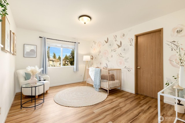 17427 92nd Ave NE, Bothell, WA 98011 - bedroom featuring wood finished floors, a crib, and baseboards
