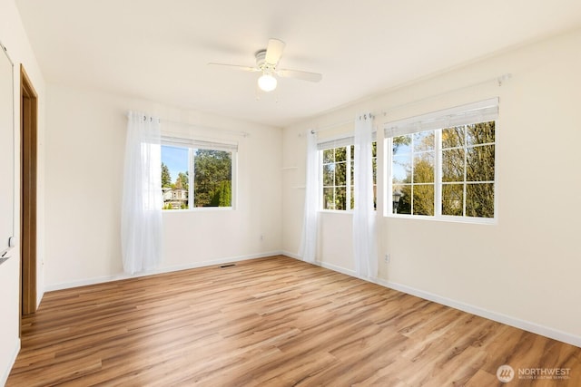 17427 92nd Ave NE, Bothell, WA 98011 - spare room with light wood-style floors, a ceiling fan, and baseboards
