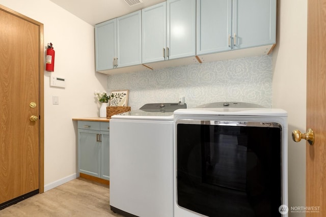 17427 92nd Ave NE, Bothell, WA 98011 - laundry room featuring cabinet space, washing machine and clothes dryer, light wood finished floors, and baseboards