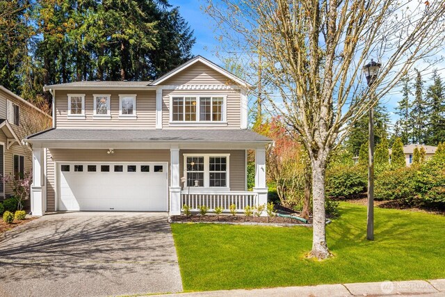 17427 92nd Ave NE, Bothell, WA 98011 - view of front of property featuring a porch, driveway, an attached garage, and a front yard