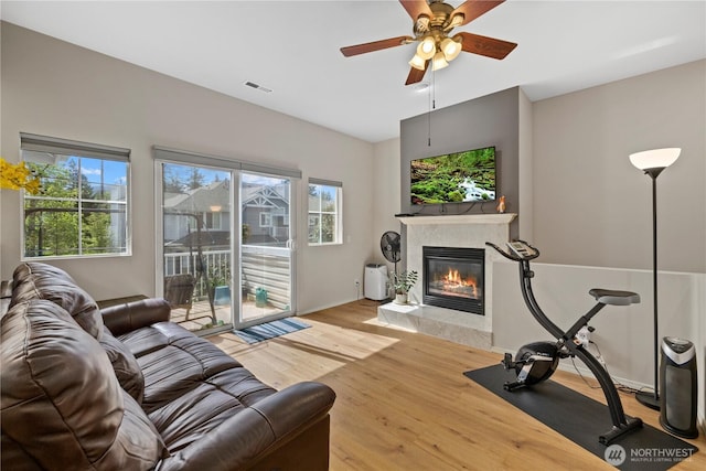 23782 SE Summerhill Ln Unit 5-4, Issaquah, WA 98029 - living room with a fireplace, wood finished floors, and ceiling fan