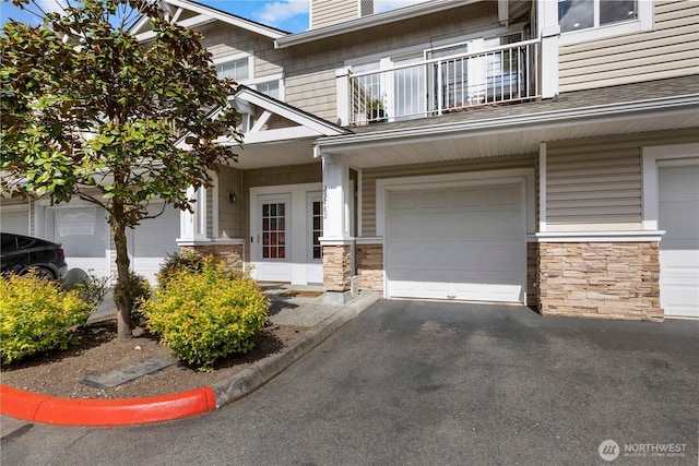 23782 SE Summerhill Ln Unit 5-4, Issaquah, WA 98029 - doorway to property with a balcony, stone siding, and a garage