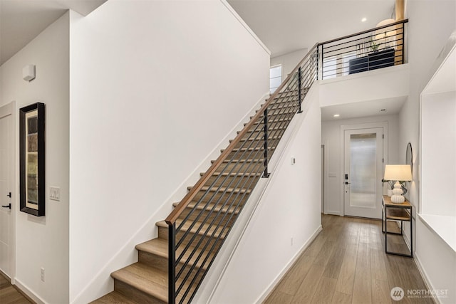 27335SITE401 NE Walden Way, Duvall, WA 98019 - stairway with wood finished floors, a high ceiling, baseboards, and recessed lighting