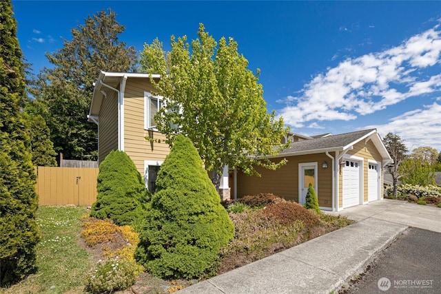 625 Argyle Ave Unit D, Friday Harbor, WA 98250 - view of front of house featuring an attached garage, concrete driveway, and fence
