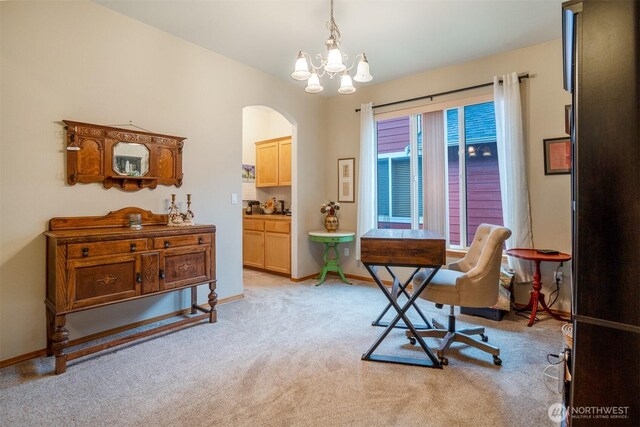 office space with arched walkways, light carpet, a chandelier, and baseboards