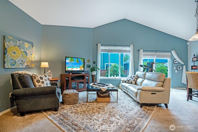 carpeted living room featuring high vaulted ceiling