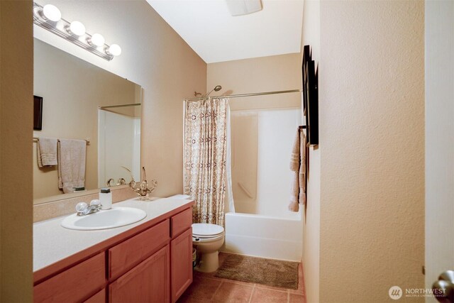 full bathroom with tile patterned flooring, toilet, vanity, and shower / tub combo