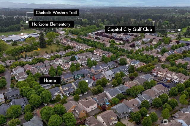 aerial view of residential area with a heavily wooded area