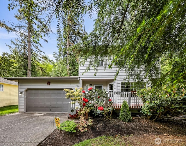 163 Polo Park Dr, Bellingham, WA 98229 - view of front facade with an attached garage, concrete driveway, and a wooden deck