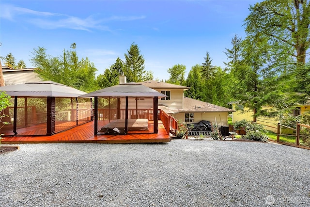 163 Polo Park Dr, Bellingham, WA 98229 - rear view of house with a gazebo, a deck, and a chimney