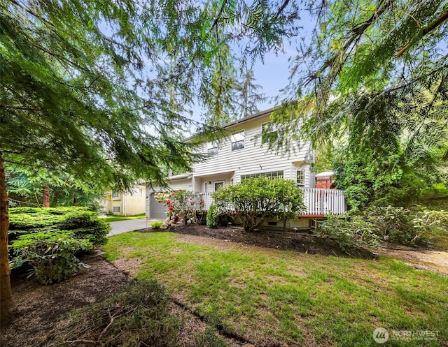 163 Polo Park Dr, Bellingham, WA 98229 - rear view of property with driveway, a wooden deck, an attached garage, and a lawn