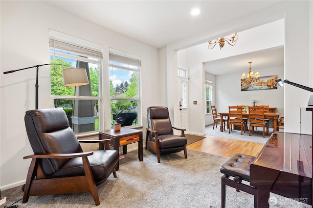 sitting room featuring a chandelier, plenty of natural light, wood finished floors, recessed lighting, and baseboards