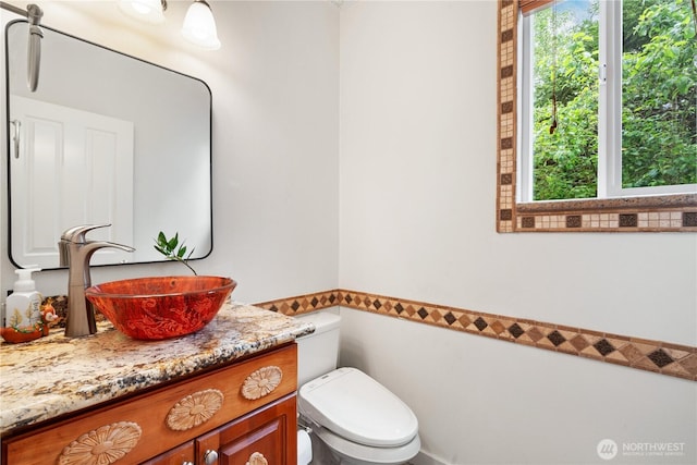 bathroom featuring vanity and toilet