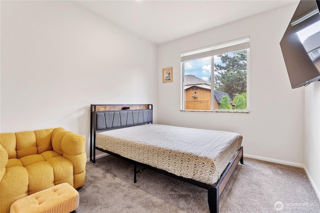 bedroom featuring carpet flooring, baseboards, and vaulted ceiling