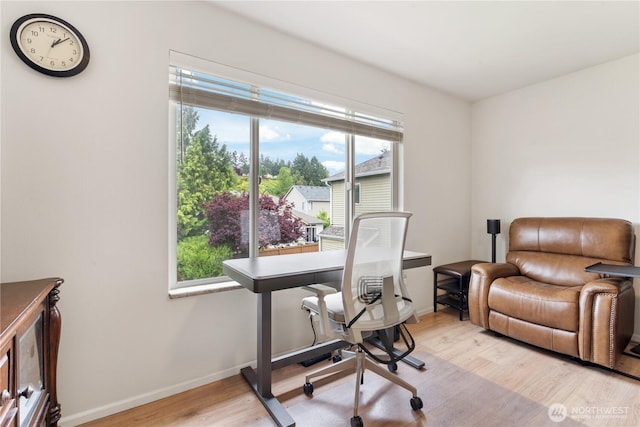 office area with light wood-type flooring and baseboards