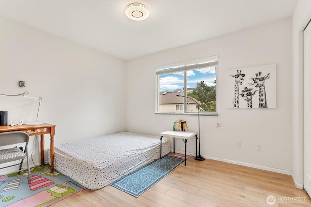 bedroom with wood finished floors and baseboards