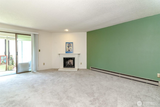 7308 N Skyview Ln Unit I-204, Tacoma, WA 98406 - unfurnished living room featuring a baseboard radiator, carpet, a brick fireplace, and a textured ceiling