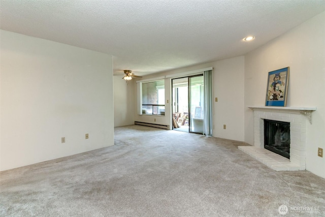 7308 N Skyview Ln Unit I-204, Tacoma, WA 98406 - unfurnished living room with a baseboard heating unit, carpet flooring, a brick fireplace, ceiling fan, and a textured ceiling