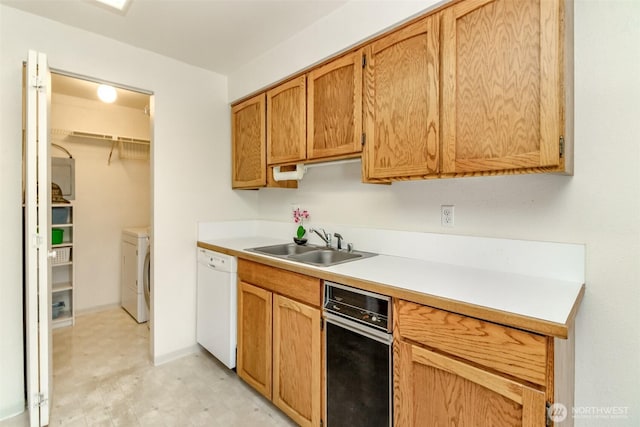 7308 N Skyview Ln Unit I-204, Tacoma, WA 98406 - kitchen featuring white dishwasher, a sink, light countertops, washing machine and clothes dryer, and light flooring