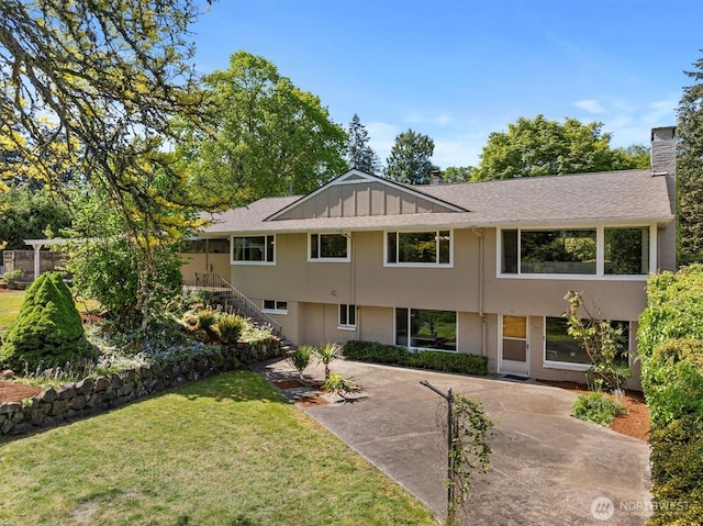 11411 Clovercrest Dr SW, Lakewood, WA 98499 - view of front of home with a chimney, stairway, a front yard, and a patio