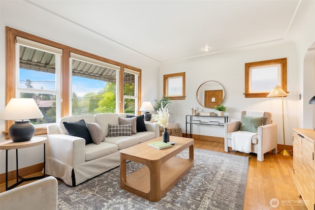 living area with light wood-style flooring and baseboards