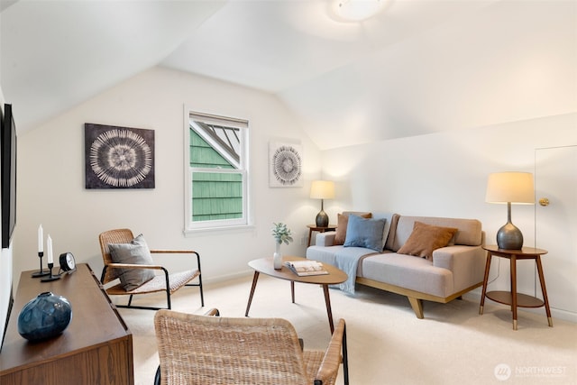 living area featuring light colored carpet, lofted ceiling, and baseboards