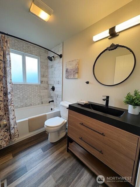 10644 19th Ave SW, Seattle, WA 98146 - bathroom with wood finished floors, vanity, shower / bath combo with shower curtain, and toilet