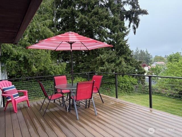 10644 19th Ave SW, Seattle, WA 98146 - deck featuring outdoor dining space and view of wooded area