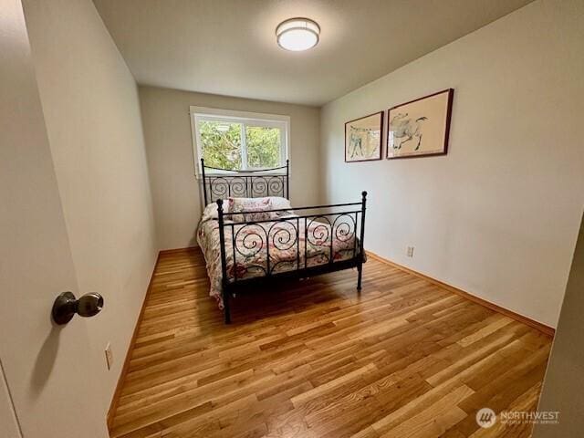 10644 19th Ave SW, Seattle, WA 98146 - bedroom featuring light wood-style flooring and baseboards