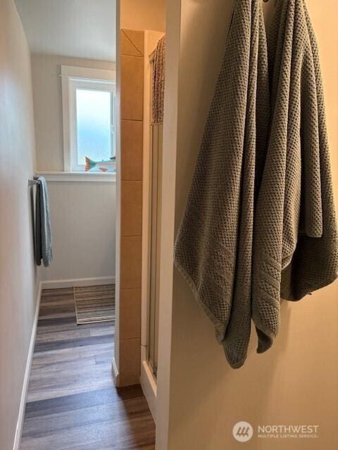 10644 19th Ave SW, Seattle, WA 98146 - bathroom with a stall shower, wood finished floors, and baseboards